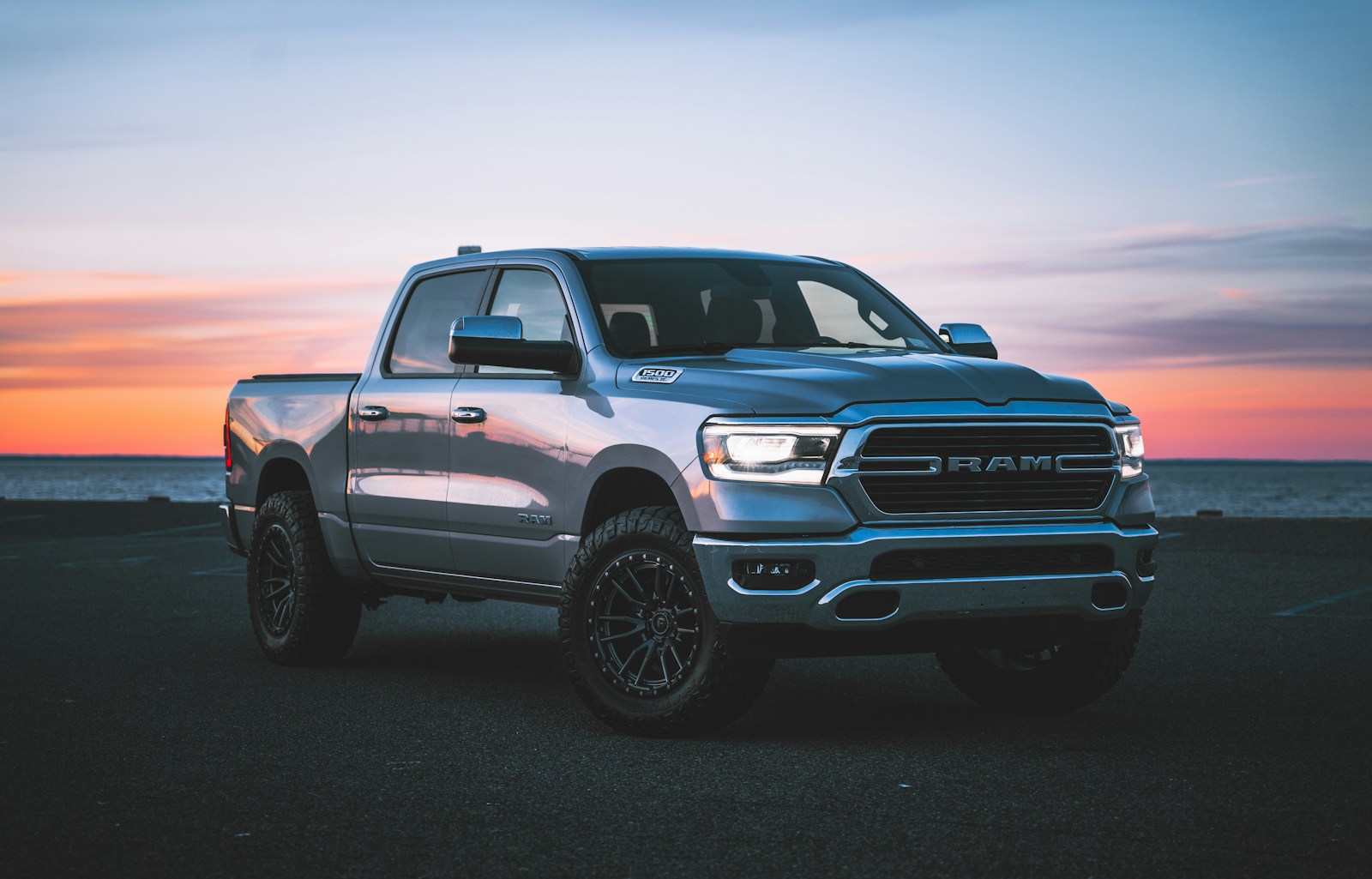 a silver ram truck parked in a parking lot